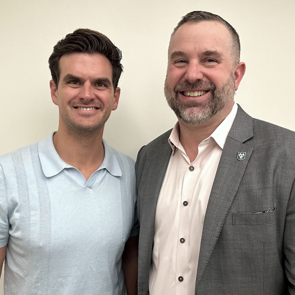 Ben Kromnick and James Zanewicz standing in front of a wall