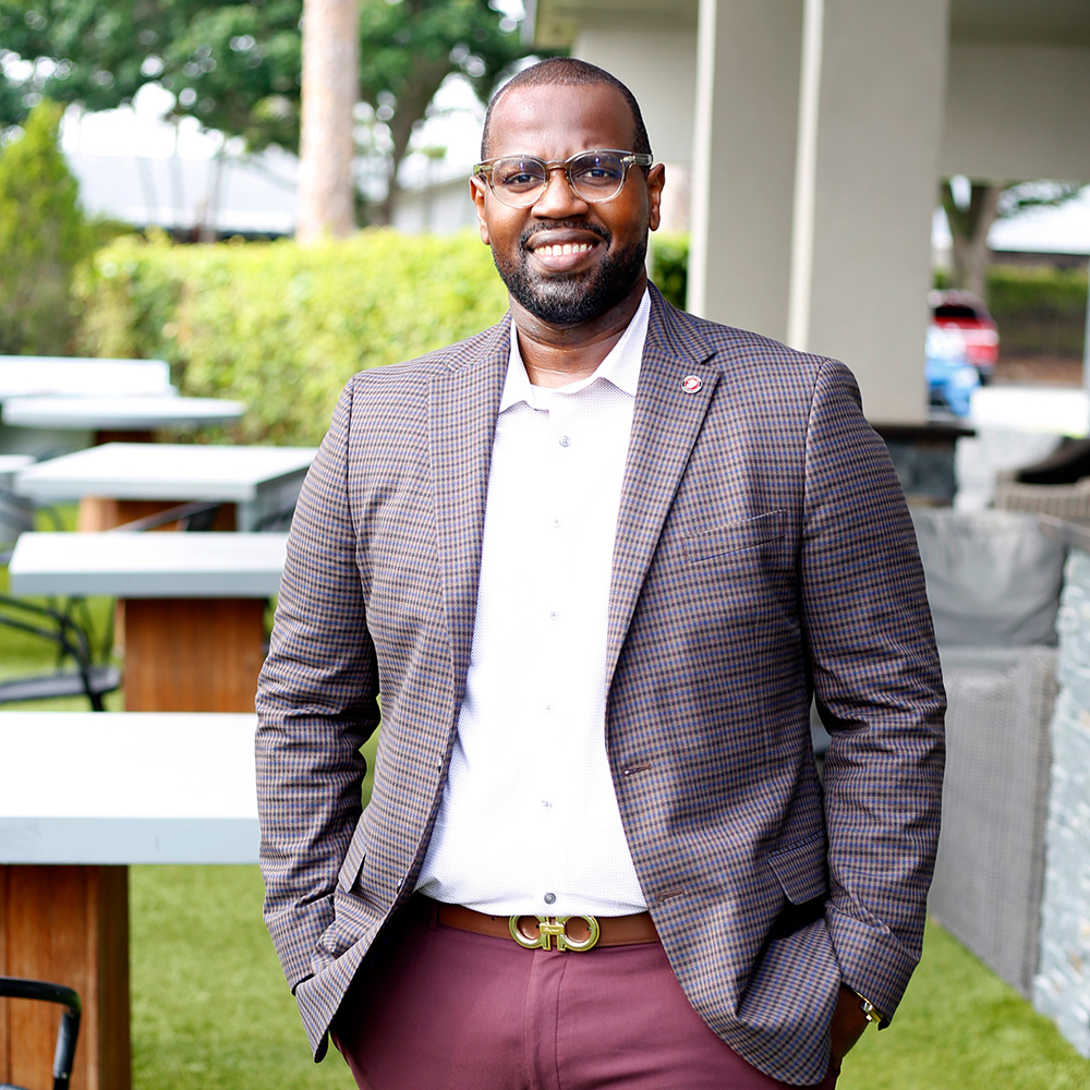 Michael Allison standing in front of grass and tables