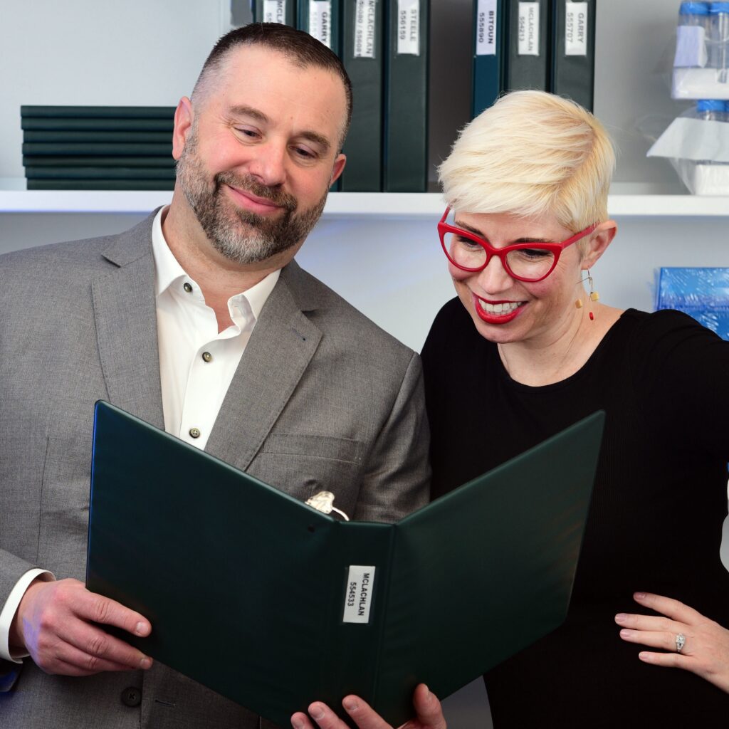 James Zanewicz and Elaine Hamm looking at a folder