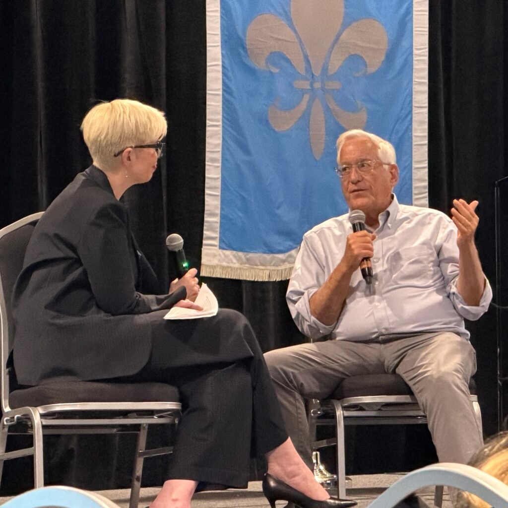 Elaine Hamm and Walter Isaacson talking on a stage