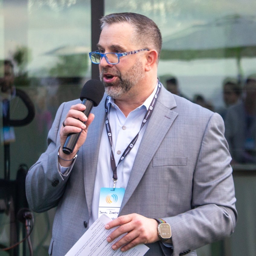 James Zanewicz talking on a mic